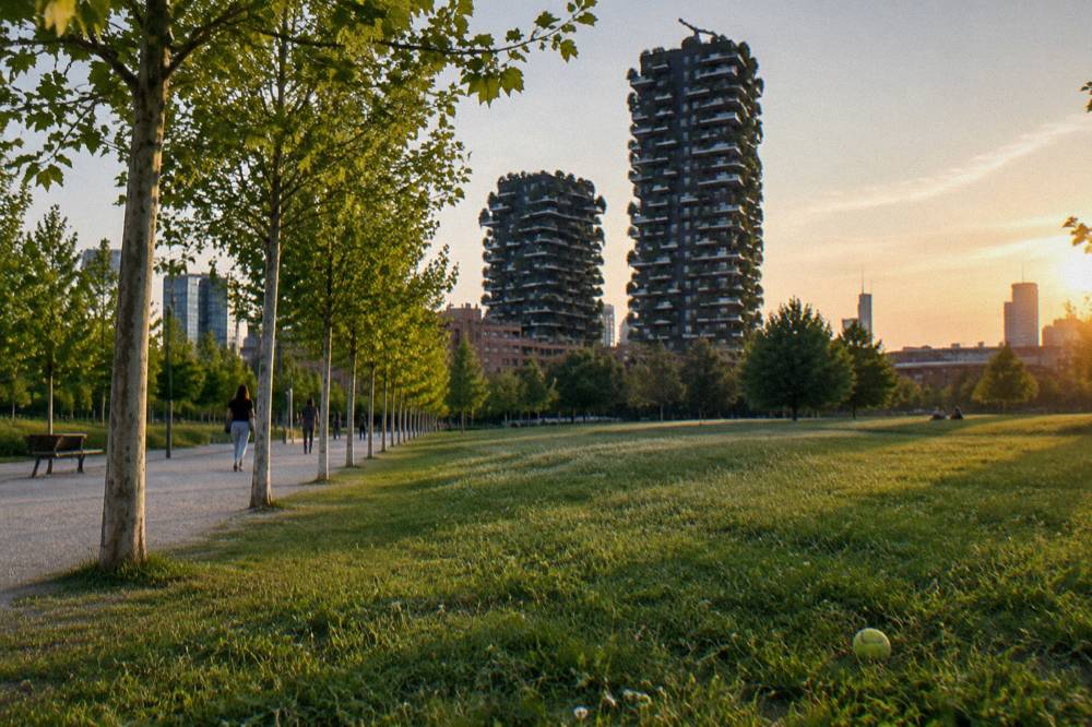 Tree-lined paths of the Biblioteca degli Alberi park leading toward the planted towers
