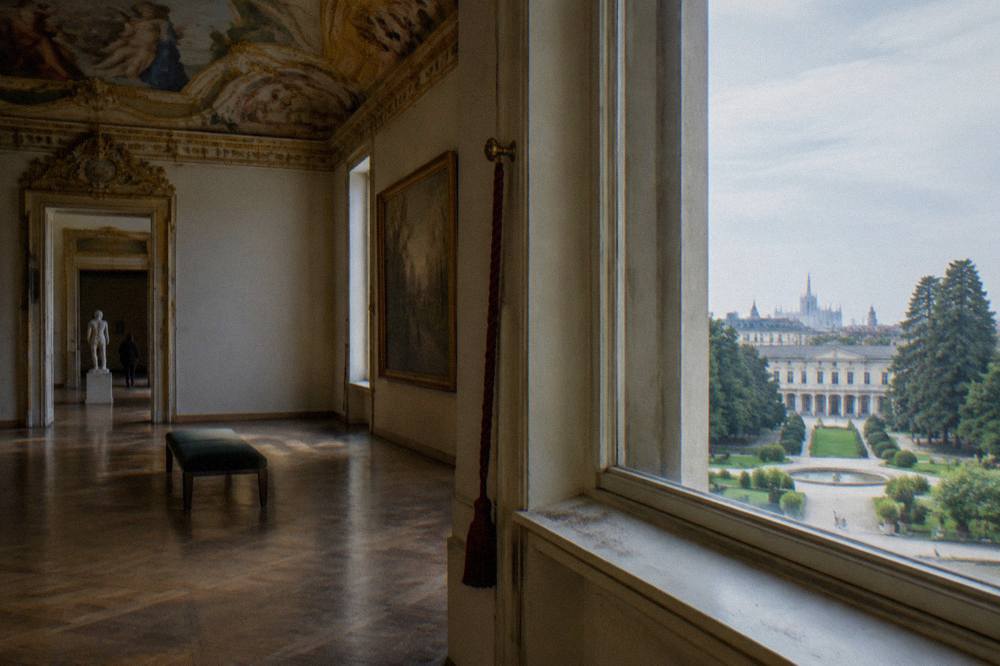 Painted gallery interior with ornate ceiling and parquet floor
