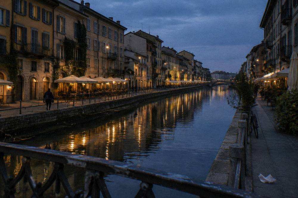 Canal street at dusk with lights reflecting on the water