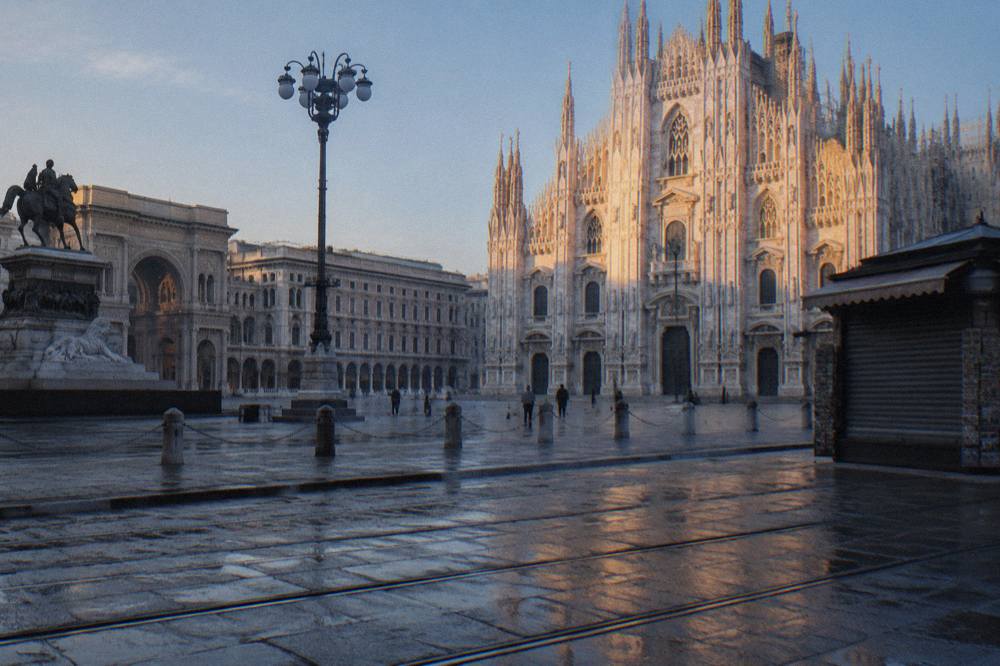 Milan cathedral marble facade seen from the square in early morning light