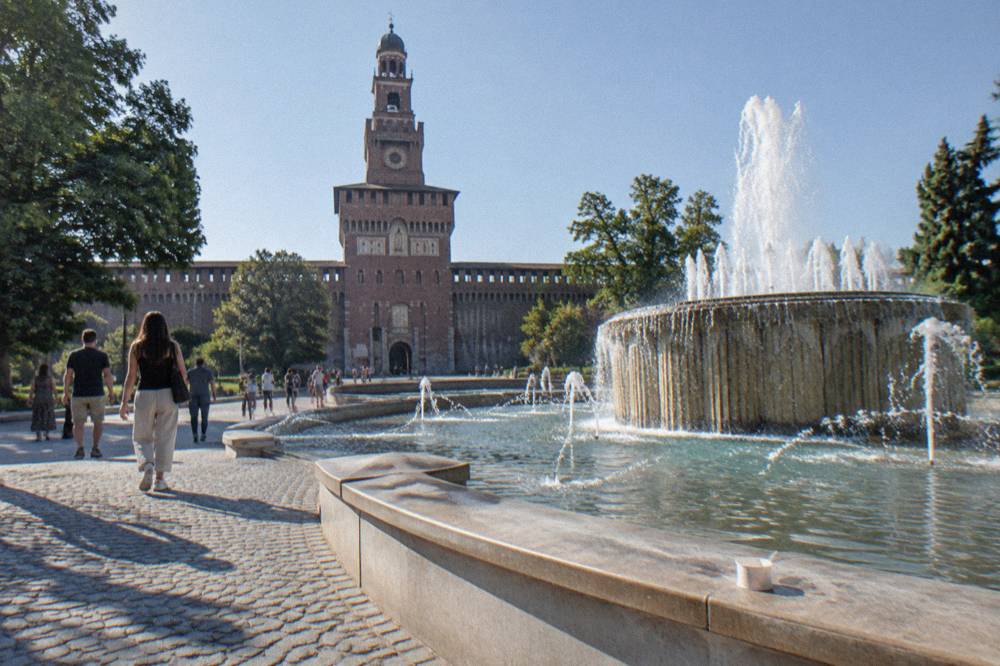 Sforza castle tower and fountain seen from the piazza outside the walls