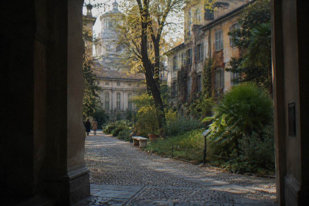 Cobbled Brera street with old painted buildings and small galleries
