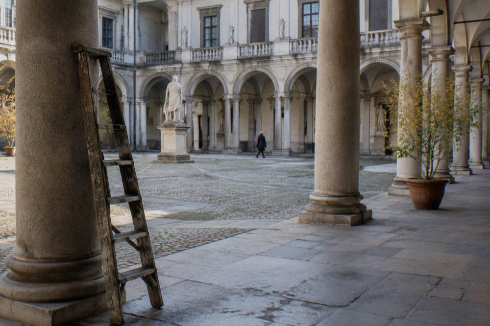 Grand colonnaded courtyard of a Milanese palace with stone arcades