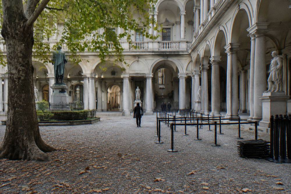 Brera courtyard with a bronze statue and pale stone columns