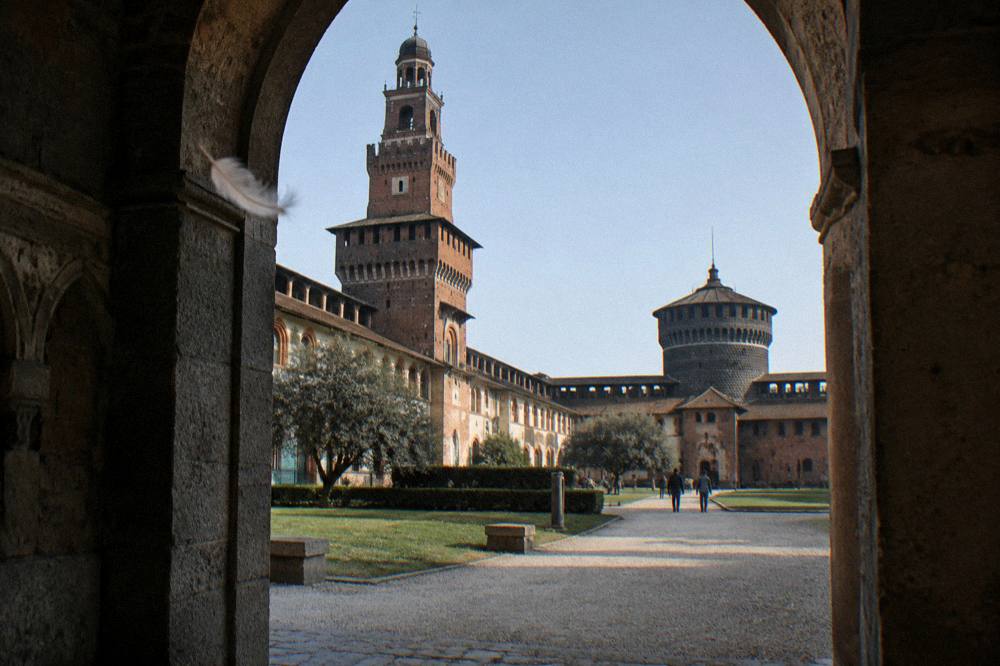 Castello Sforzesco courtyard archway with brick towers against open sky