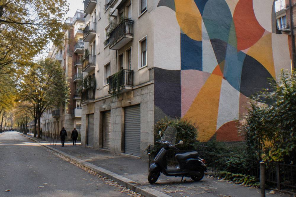 Painted mural covering the side wall of a residential building in Isola