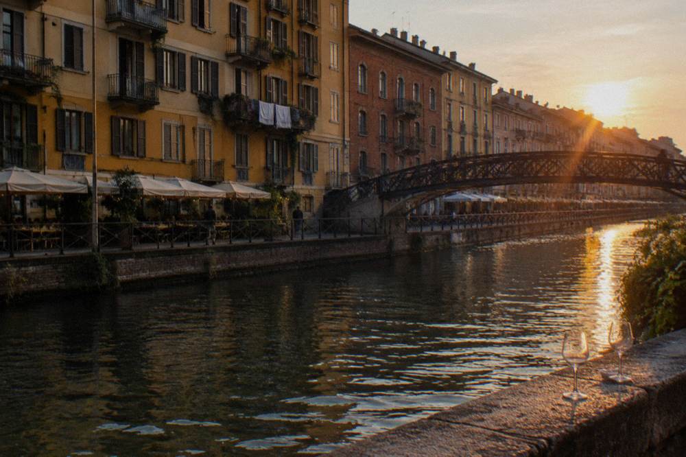 Canal-side street in the Navigli district with reflected evening light on the water