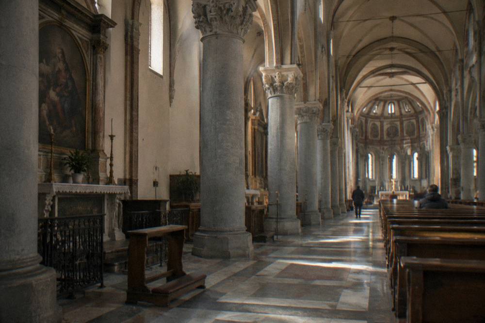 Interior of the Santa Maria delle Grazie church nave with columns and vaulted ceiling